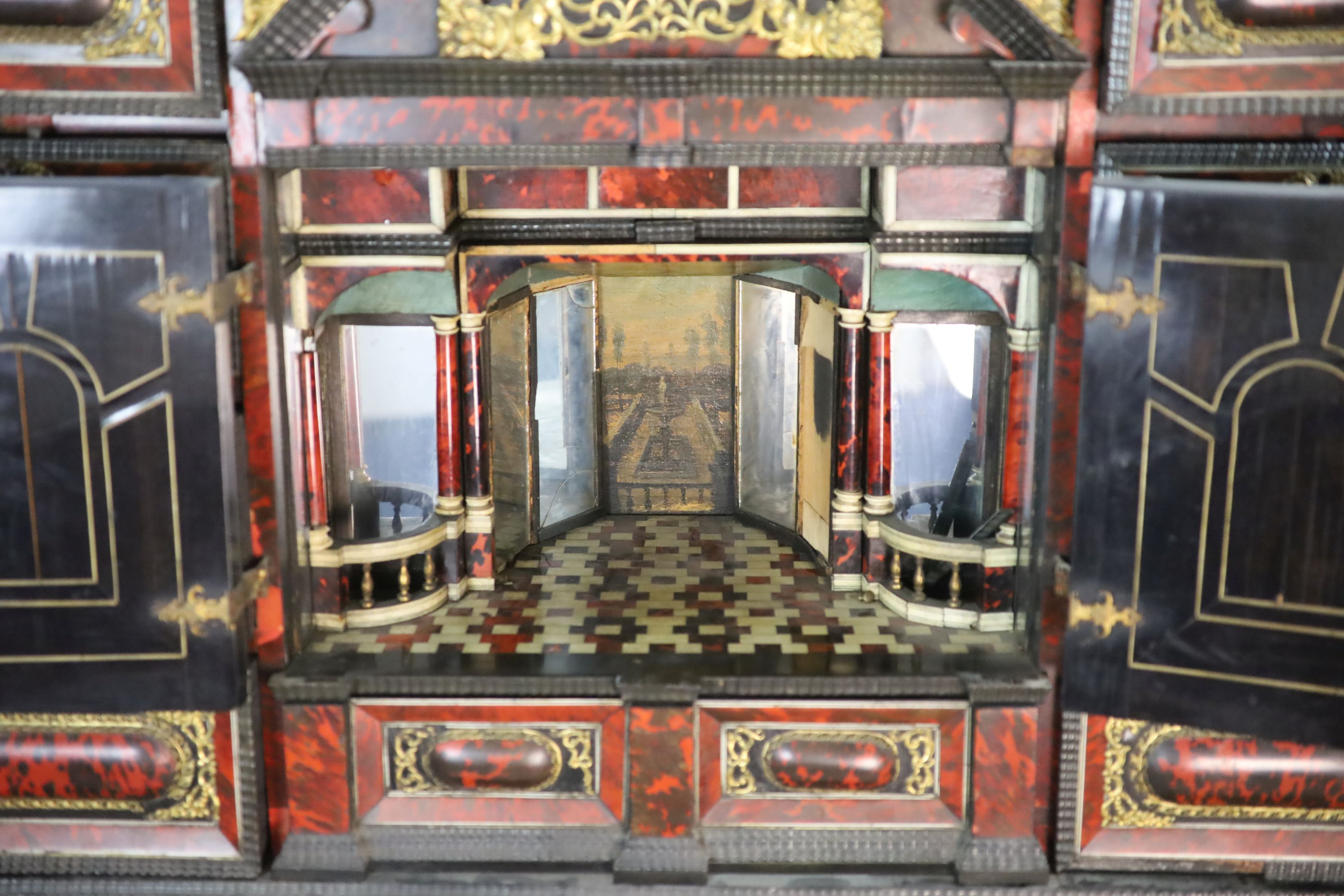 A late 17th century Portuguese ormolu mounted ebony and red tortoiseshell cabinet on stand, W.124cm D.46cm H.187cm